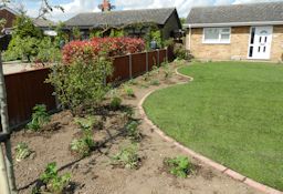 New Turf and brick edged borders with intial planting