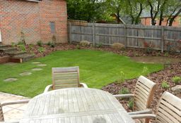 New Turf with inset stone path, circle patio and low maintenance borders