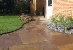 New Patio with slate covered flower bed and feature planting
